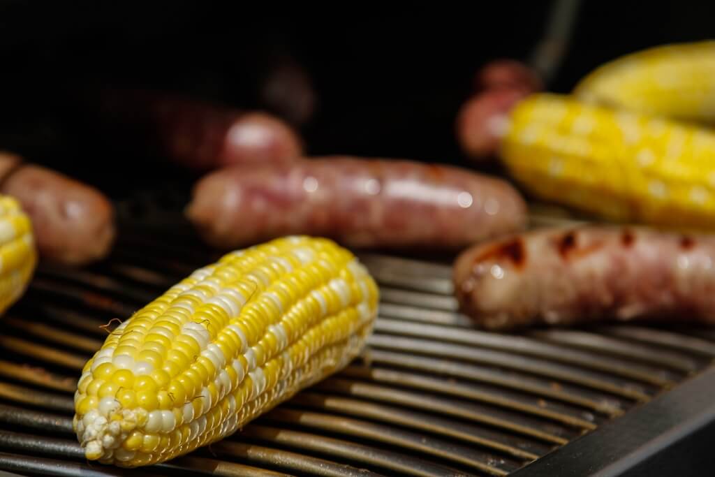 corn and sausages on grill