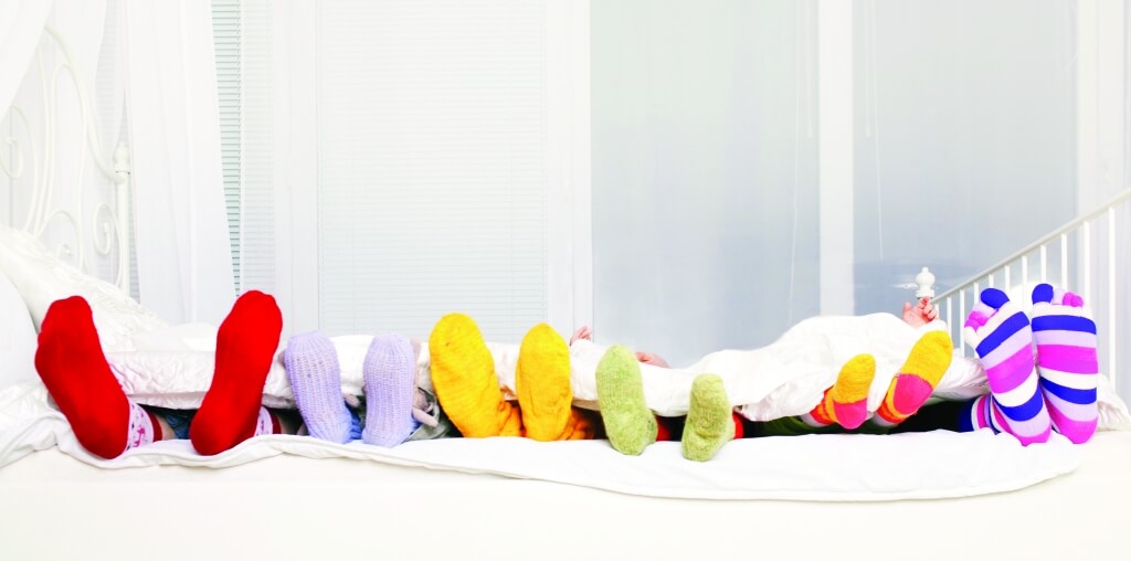 warm toes under a blanket with fun socks on