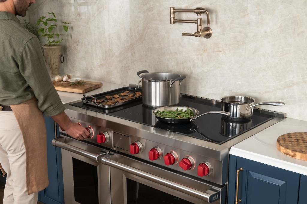 Man cooking on a 48-inch Wolf induction range